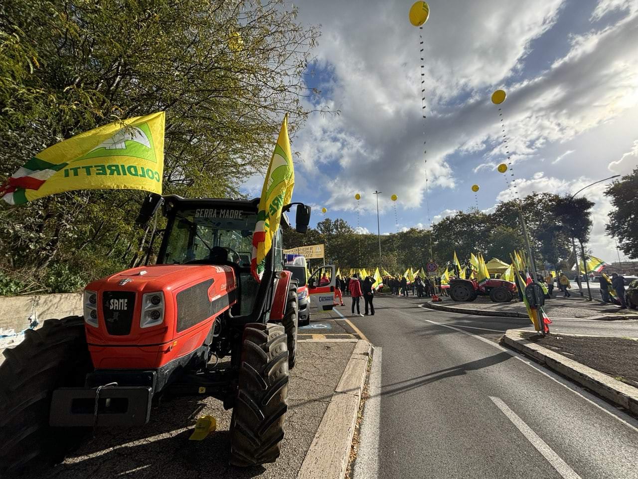 Manifestazione Coldiretti davanti alla Regione Lazio con trattori e bandiere gialle, espressione di protesta agricola.