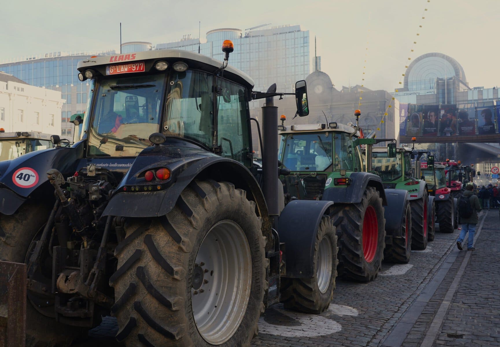 Trattori in fila durante una protesta, evidenziando la richiesta di intervento per lo stato di crisi agricola in corso.